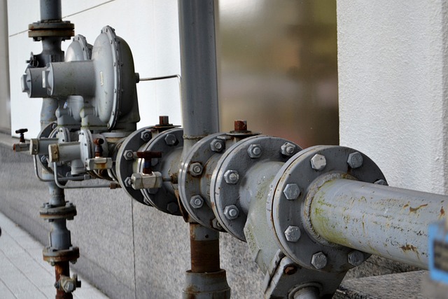 Close-up of aged industrial pipes and valves, components of sewer systems in urban environments